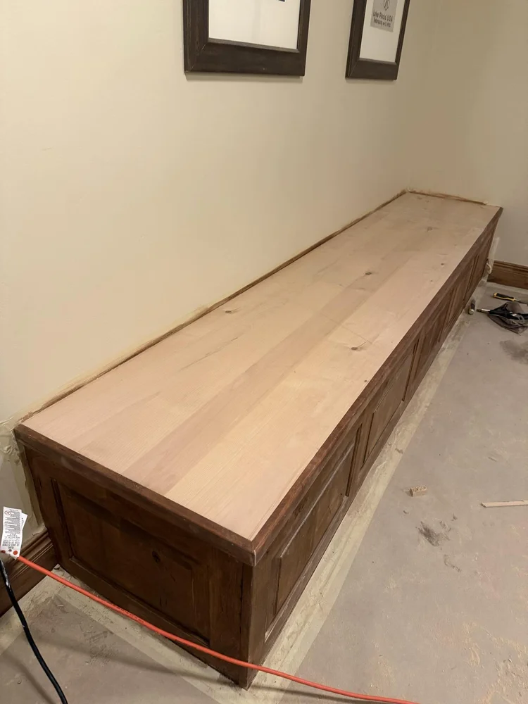 Custom built-in storage bench installed along a hallway wall