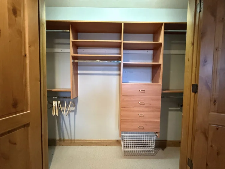 Custom closet build-out with shelving, hanging rails and drawers