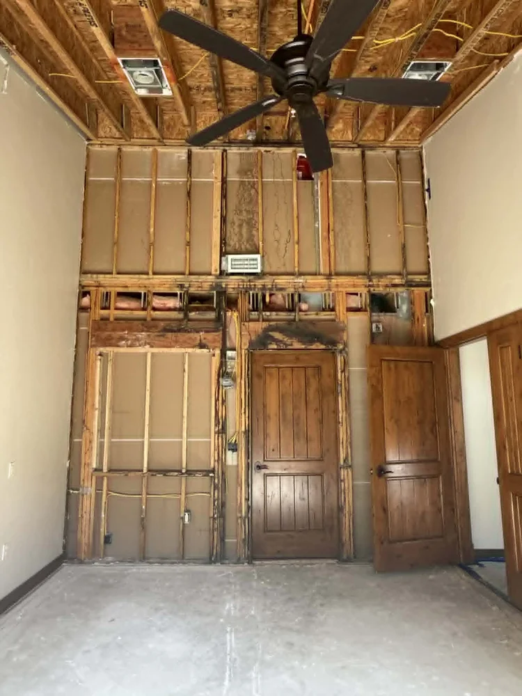Interior remodel in progress with wall framing exposed and knotty alder doors, Park City