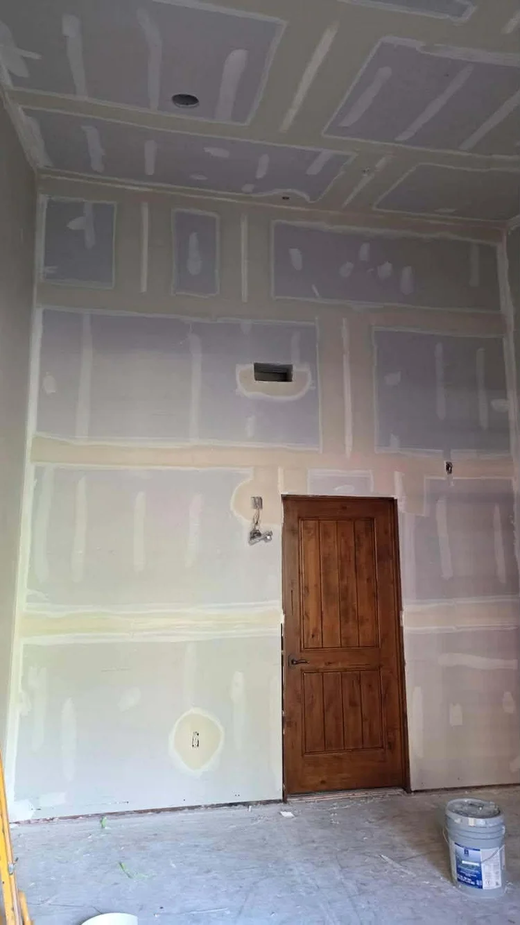 Drywall taped and mudded around a new knotty alder door