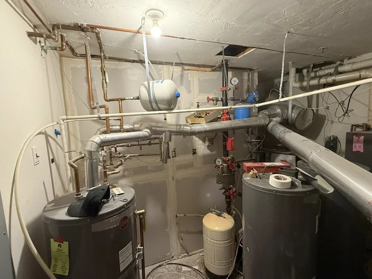 Mechanical room with water heaters, expansion tank and copper plumbing