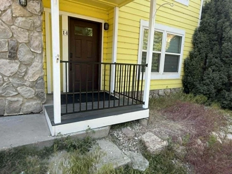 Front entry porch with new metal railing and repaired decking
